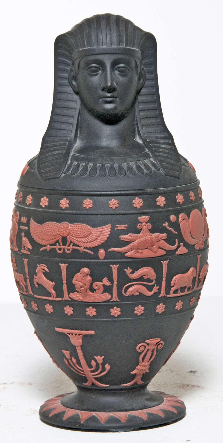 Modern jar made by Wedgewood. The black lidded footed canopic jar decorated with terracotta applied Egyptian symbols; limited edition 39/500