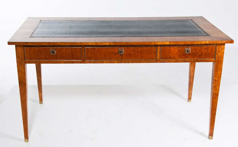 A great old Swedish birch wood desk or writing table with black leather inset top and brass trimmed drawers.