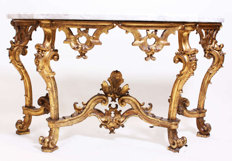 A 18th Century Italian Rococo gilt wood console with a white marble top (replaced). Possibly from the Turin Region of Italy.