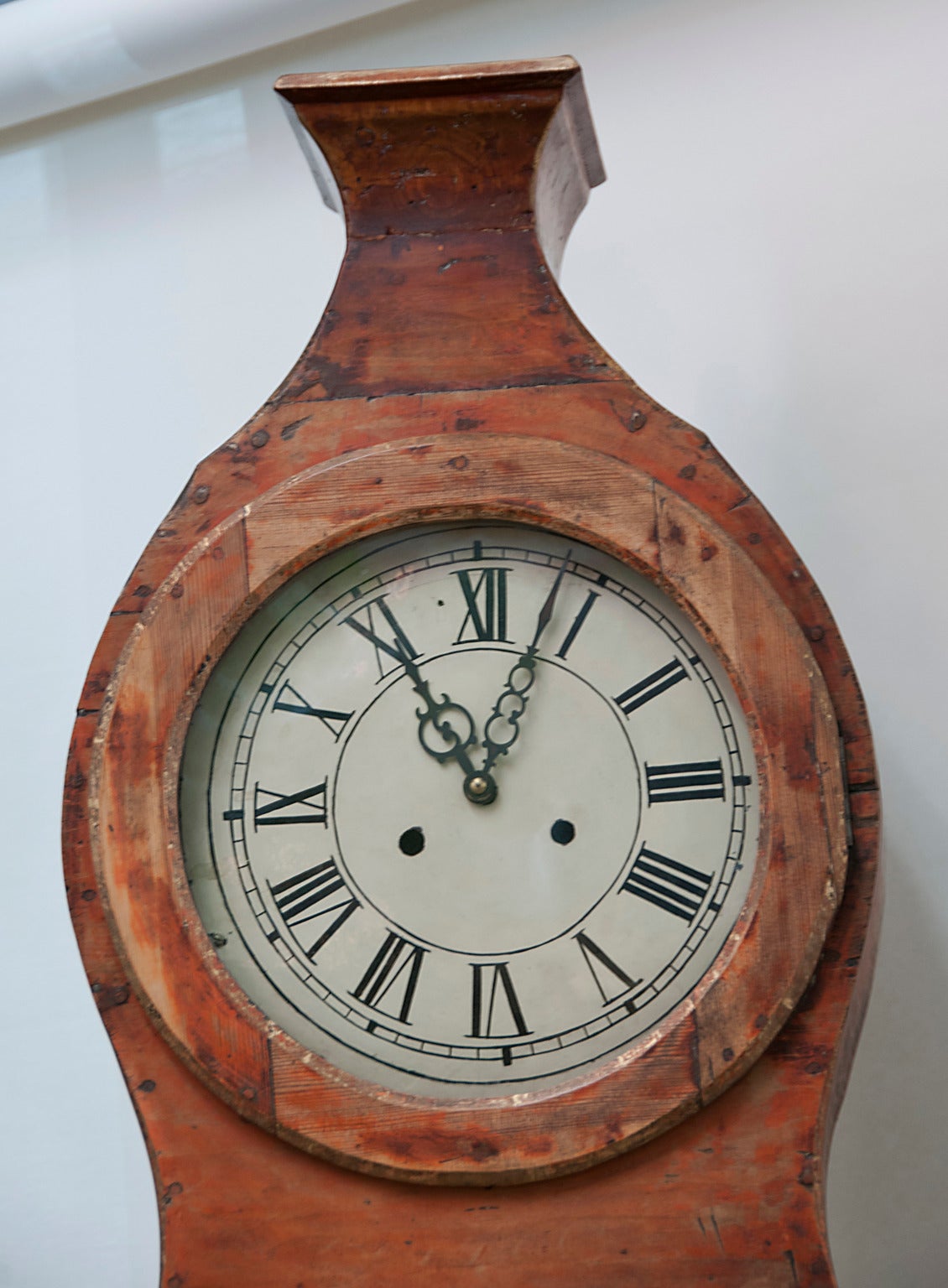 A 19th century Swedish painted tall case clock. Repairs to the base. Many layers of later paint removed to reveal some original paint and pine. Working condition. A nice example of a Provincial piece from circa 1830. We love the color and the