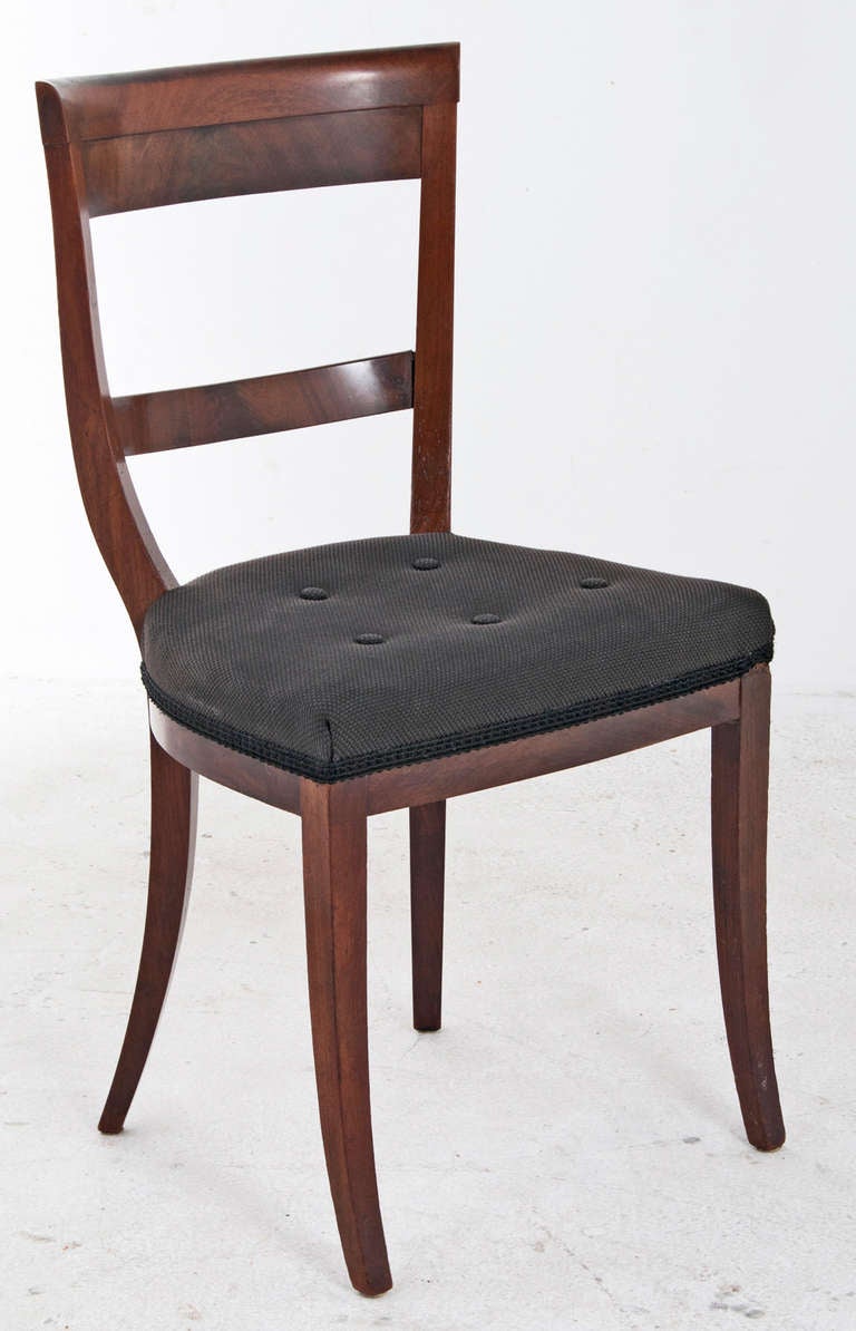 A classic set of six chairs made in Northern Europe about 1840 with wonderful buttoned seats and well figured wooden veneers.   This design is loosely based on the klismos chair of Greek antiquity with and exaggerated barrel shape.  These chairs are