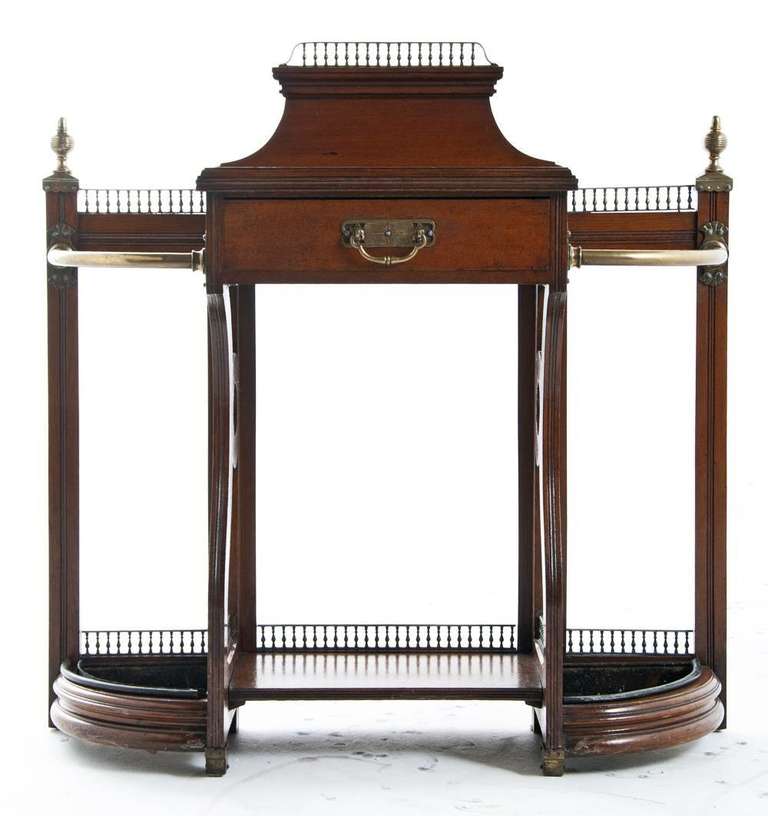 A nice and well proportioned Edwardian mahogany hall table incorporating a drawer and umbrellas stands made circa 1910 in England. A nice old finish. A useful and well scaled table for your entry hall.