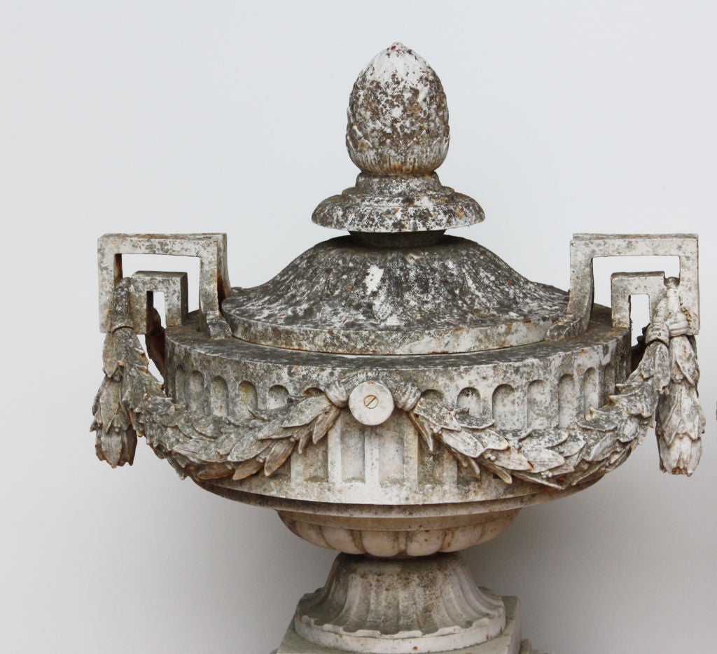 An amazing and large pair of cast iron Louis XVI style neoclassical urns by the famous Paris firm 