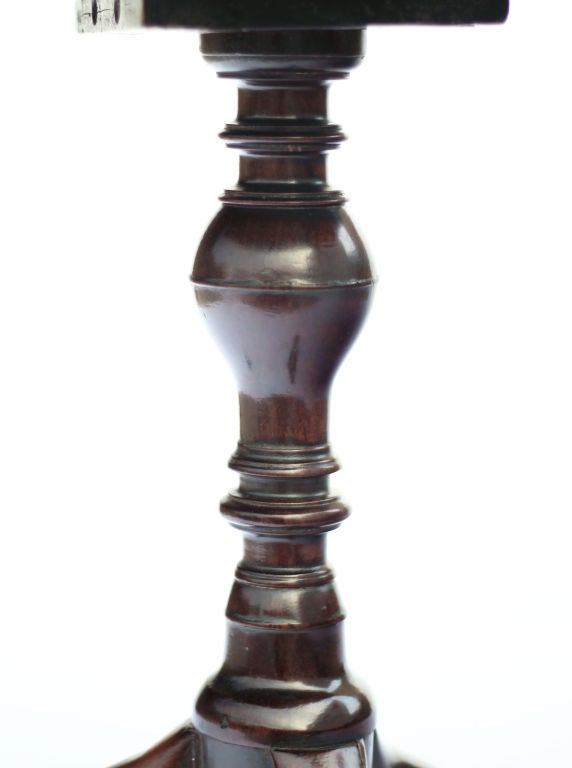 A very nice mid Georgian mahogany tripod pedestal made in England during the second half of the 18th century. Good color and patina. The top is a beautiful single board of flame figured Cuban mahogany. Beautiful turned baluster with original