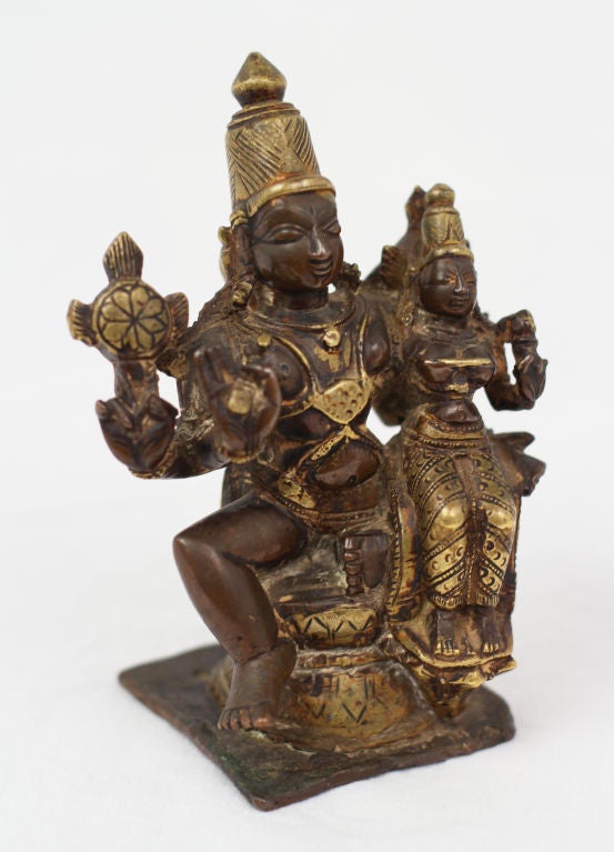 A charming bronze figure of  Shiva and Parvati.   Shiva the god of rejuvination and  destruction.  Parvati the goddess of love.  They are the parents of the elephant headed god Ganesha.