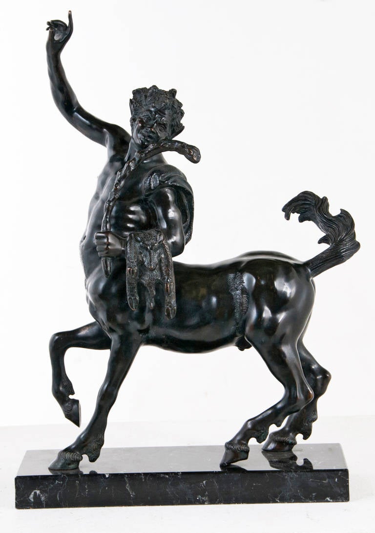 A well done and whimsical laughing bronze Grand Tour centaur, circa 1920 on later marble base.  Nice patina and color.