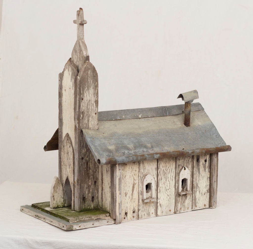 A great looking weathered American folk art bird house with old paint and a zinc roof.