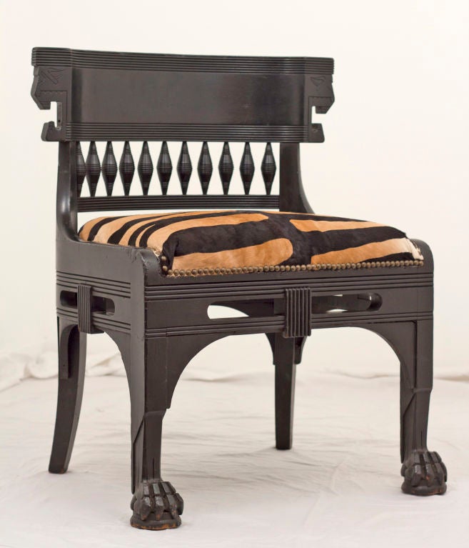 I love this chair.   It is over scaled, masculine, solid and incorporates the designs of ancient Egypt and Greece.  Built to last and to command attention.