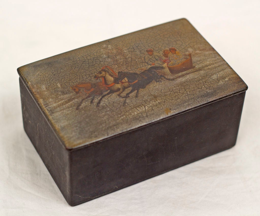 Top featuring a winter (snow) scene of three horses pulling a sleigh with figures.  Red interior with impressed 