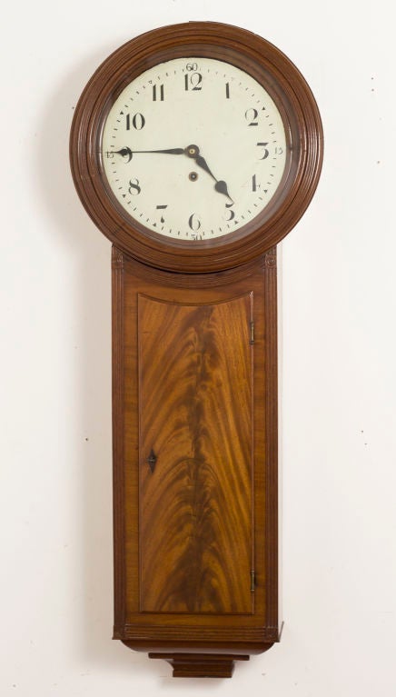 A good looking Regency mahogany tavern clock made in England early in the 19th century. The case features nicely figured veneers with reeding. In working order. Recently polished with the works cleaned and tuned up. Less than 2% of our inventory is