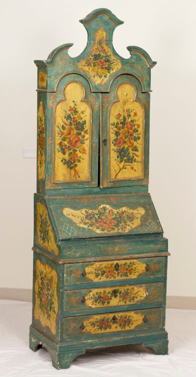 An attractive painted Venetian Secretary cabinet made in the 1920's with the intention that it would look like it was very old.  Done in the mid 18th century style.  Decorated in greenish blue with panels of flowers on a yellow ground.   Less than