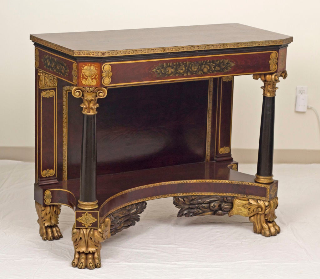 A great early 19th century fancy painted American console in mahogany with ebonized accents.  Painted all over in gold with scrolls, garlands and borders.