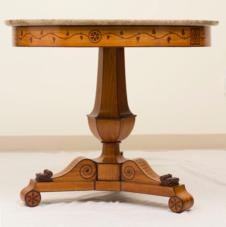 Round satinwood table / center table with rosewood inlaid details of vines, pinwheels and banding.  Strong neoclassical references.  A very handsome piece.