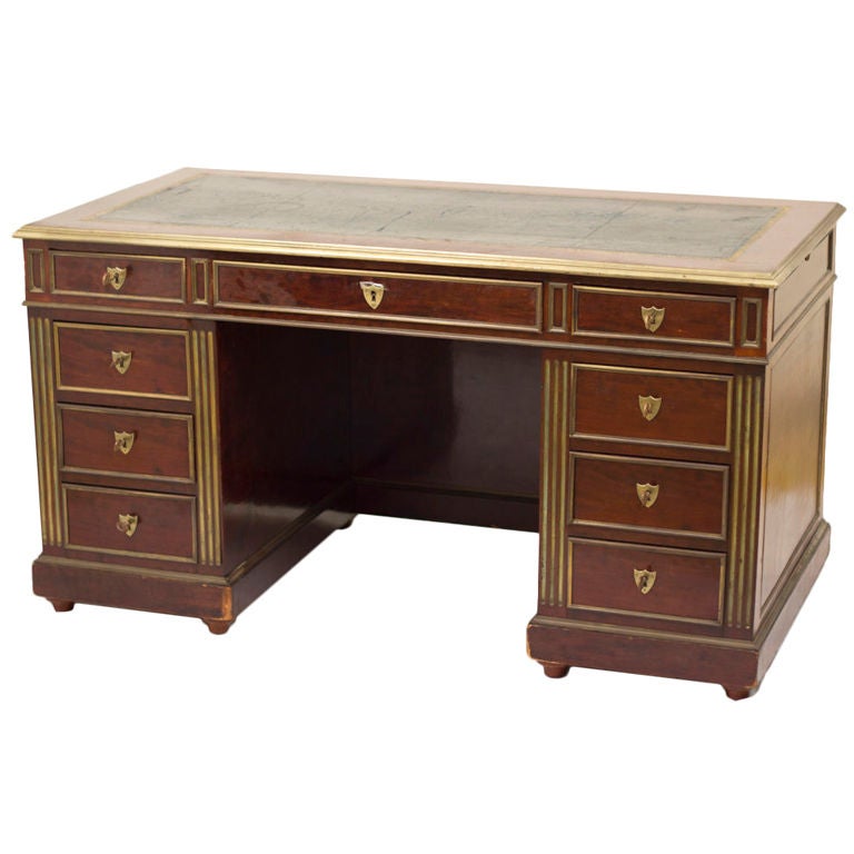 A very elegant Louis XVI style mahogany pedestal desk made in France during the second half of the 19th century. Nicely finished on four sides, designed to sit in the middle of a room. This desk also has two pull-out work surfaces with inset