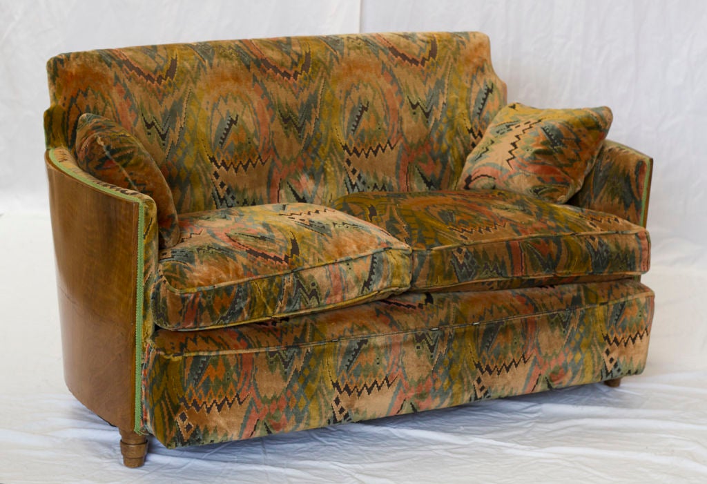 A handsome vintage walnut sofa / settee in vintage upholstery.  Nice smaller scale.
