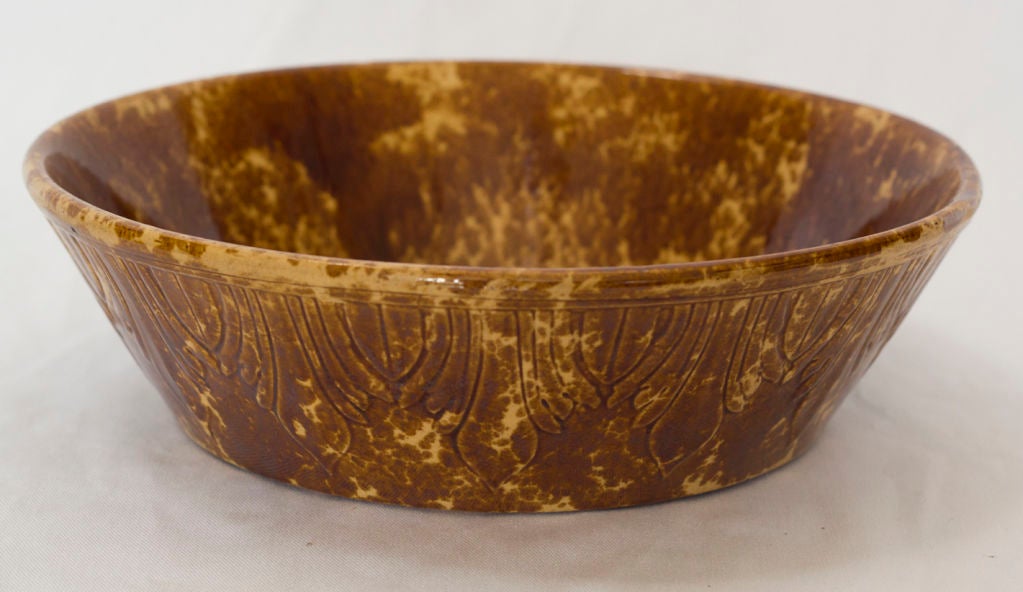A handsome and large tortoise shell spongeware bowl with incised decoration.