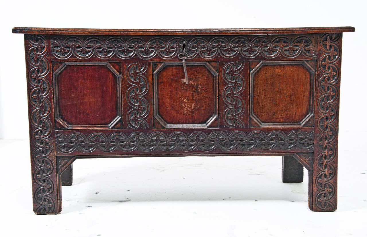 Displaying robust deep carving typical of North country furniture of this early 17th century period.  Wonderful color and detail with chip carving extending down stiles and lower rail on the feet.  This example particularly rare as it retains its
