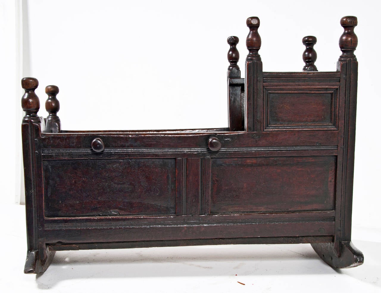 Rare English oak dated cradle, circa 1706. Good color with attractive finials originally used for tie on covers. Great color and patina with most probably original finish. Found in the lake District Cumbria England. From a very good collection.
