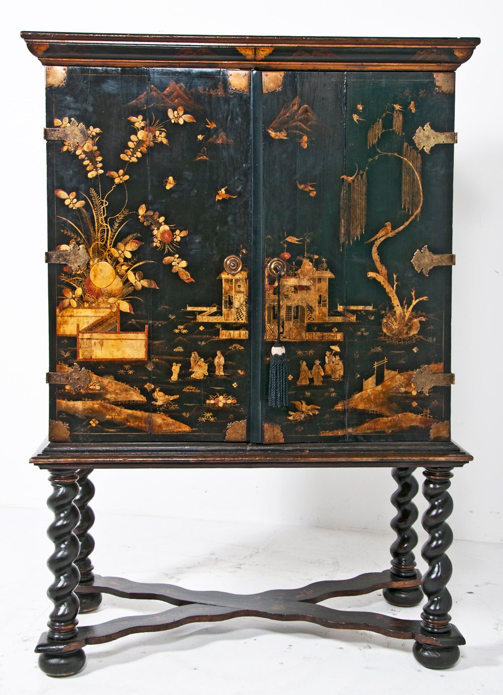 A very nice example of a lacquered cabinet on stand decorated in the Chinese style but made in Holland or England early in the 18th century.  During this period the best of everything came from the Orient and English and Continental imitations where