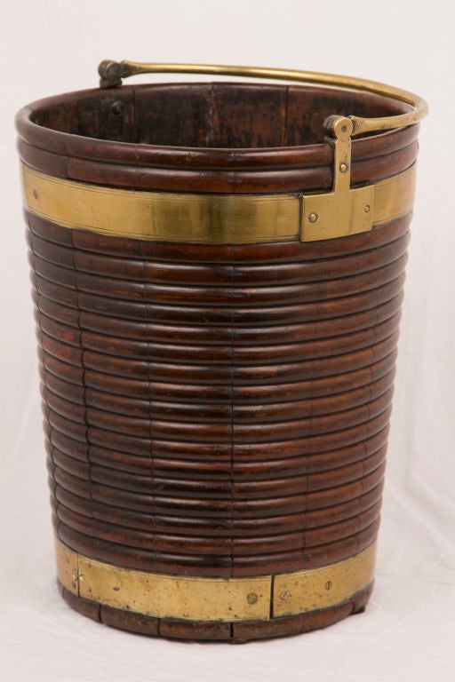 A great mid Georgian brass mounted mahogany peat bucket made in Ireland.