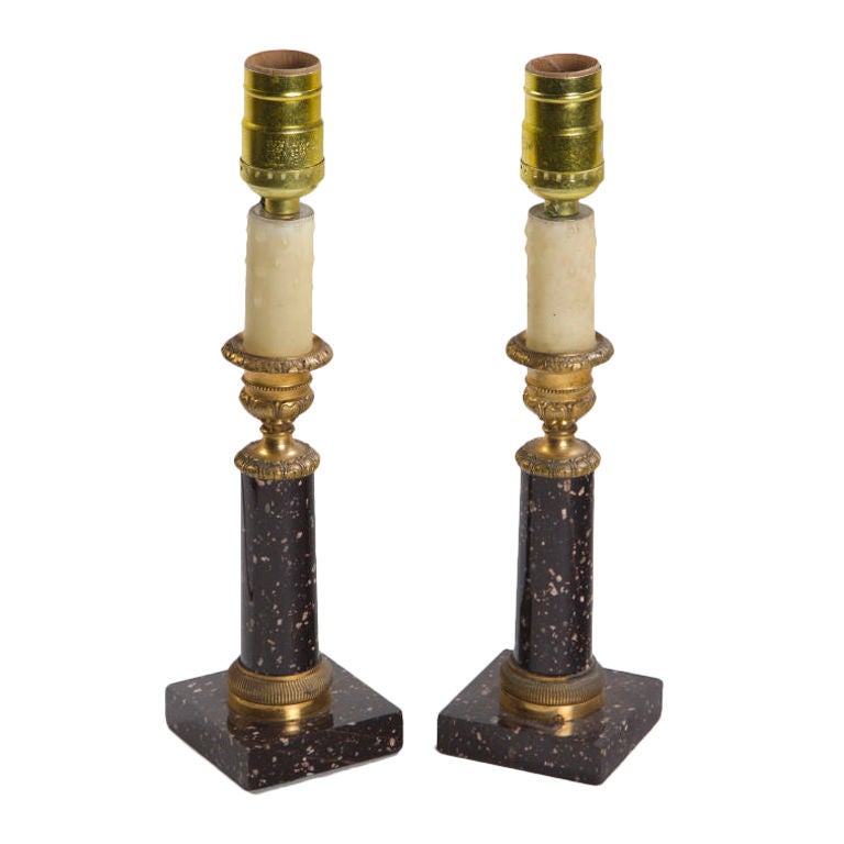 A rare pair of antique  Swedish porphyry and gilt bronze candlesticks mounted as lamps.
