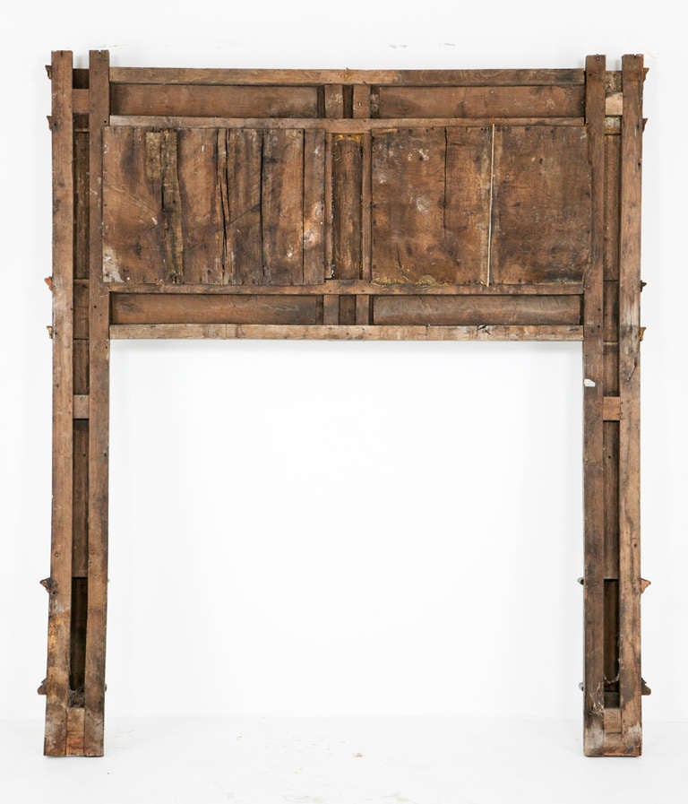 A rare and wonderful Gothic fire surround made in England in the 16th century and later (with repairs and restoration). At a complete loss to explain why image 5 is so light. The piece has an overall dark color with a fairly dry finish. We have had