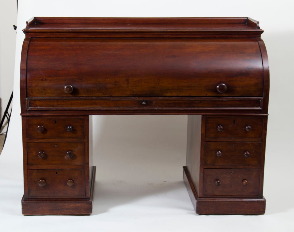 A fantastic antique English mahogany roll top desk with fitted birds eye maple interior.  Made by Richards and Co in London during the second half of the 19th century.  30