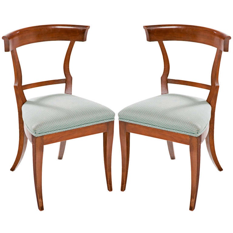 A set of 12 chic Klismos walnut side chairs probably made in Italy about 1900. This model chair was first made in Ancient Greece about 2400 years ago. There was a very strong revival of neoclassical design and this chair design in particular about