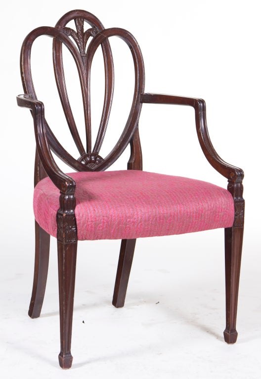 A classic beautifully carved Sheraton style mahogany arm chair made in England during the 1950's