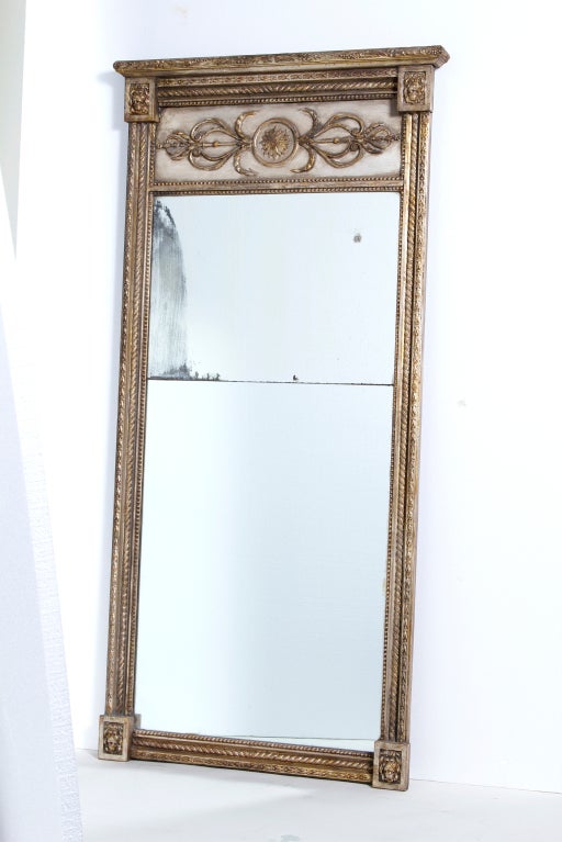 A really good looking neoclassical mirror made in Northern Europe (Sweden, Denmark or Russia) 19th century.   Made of carved painted and gilt wood with old mercury glass split mirror plate.   We will replace the mirror of you or your client does not