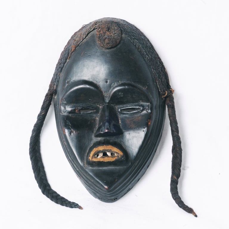 An authentic Dan mask made in Africa during the 19th century. These pieces are prized for their geometry, strength and patination. It is not difficult to see the role artifacts like these played in the development of cubism and Picasso's Le