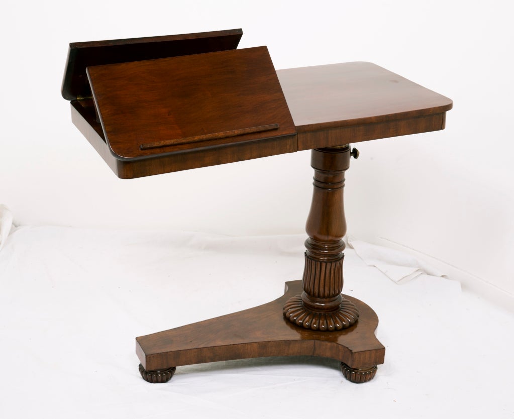 A nice mahogany adjustable music or reading stand in mahogany with original brass mounts.  The table top is adjustable as it raises or lowers.  The Easels are adjustable as well.  There is a secret drawer in the tables apron.