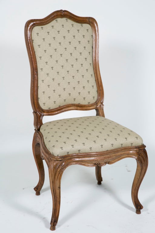 The large beautiful walnut chairs are based on Venetian originals first made about 1740.  It is not hard to see the influence Louis XV furniture has on this design.  We like the extra size and curves along with the less ornate carving.  They are