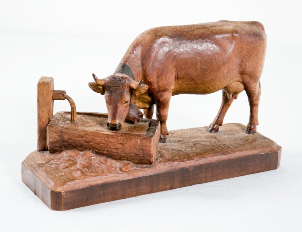 Amazing hand carved early 20th century Swiss Black Forest wood carving of a cow at trough.  Figures like this were sold to wealthy tourists over the summer and carved during the winter.