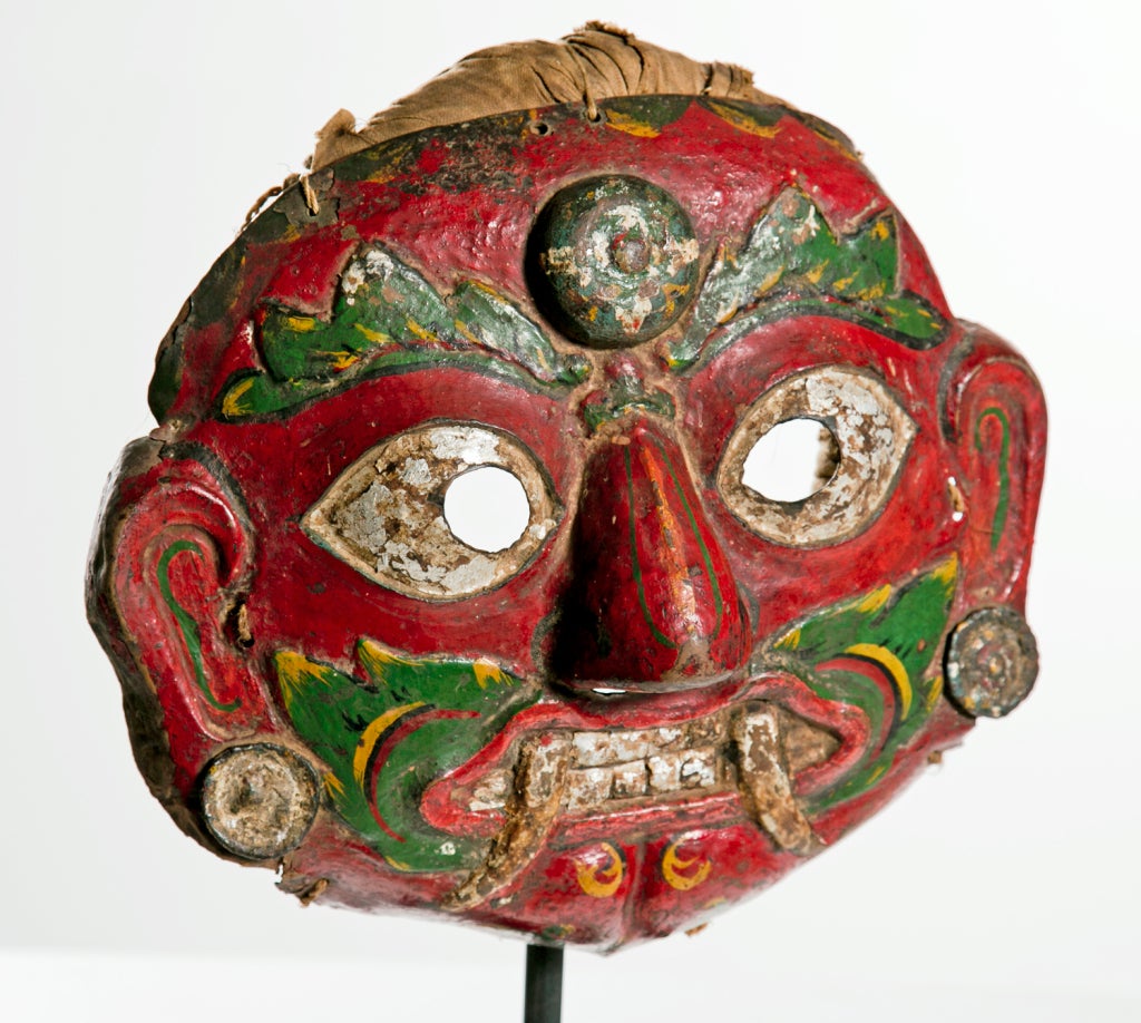 This ferocious face is often seen over door ways in many parts of Nepal.  I think the deity is named Bhavira and the main task that  he / she is charged with is scaring off evil infulences.  This is a dance mask used for various festivals.  We think
