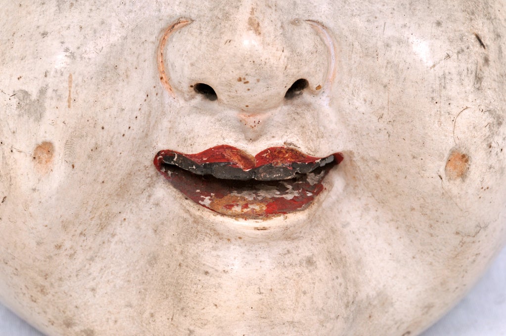 A rare and charming Japanese Noh mask made about 1840.  This mask depicts a plump beauty with jett black hair, ruby red lips and charcoal stained teeth.  We love the pleasing and happy countenance this mask projects.  This comes from a large