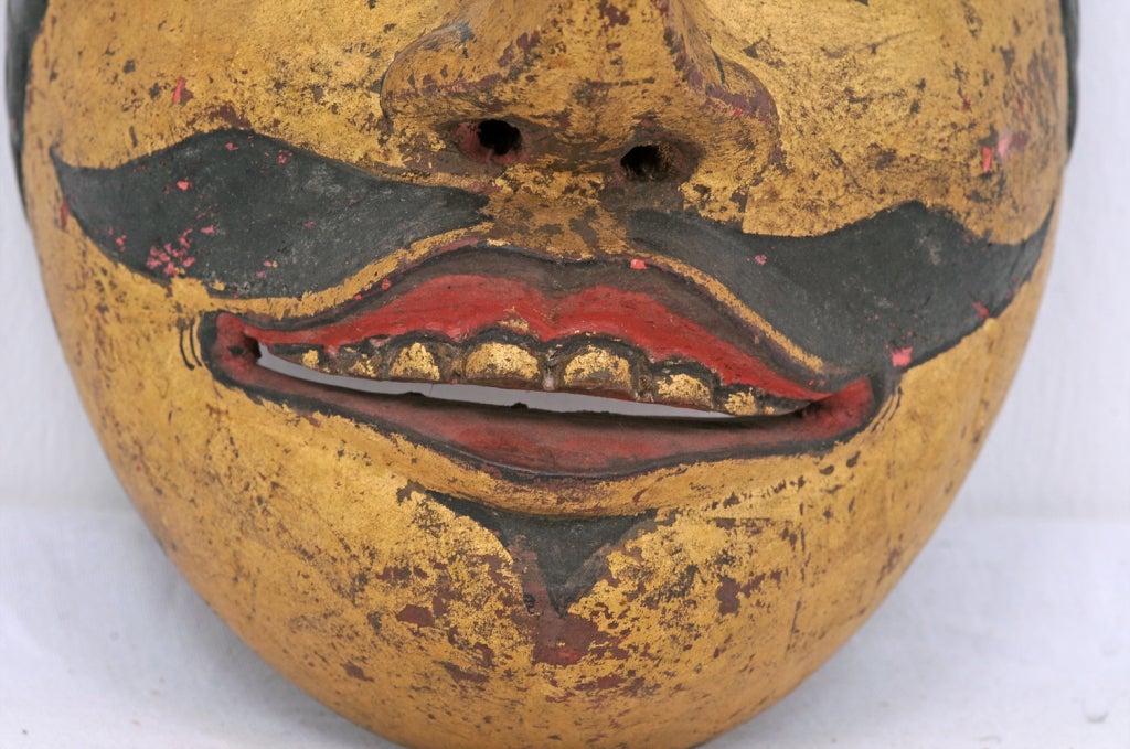 A great antique dance mask of a prince in carved wood with paint and gilding.  This mask is from Indonesia and dates from the first part of the 20th century.  This is from an old west coast collection.