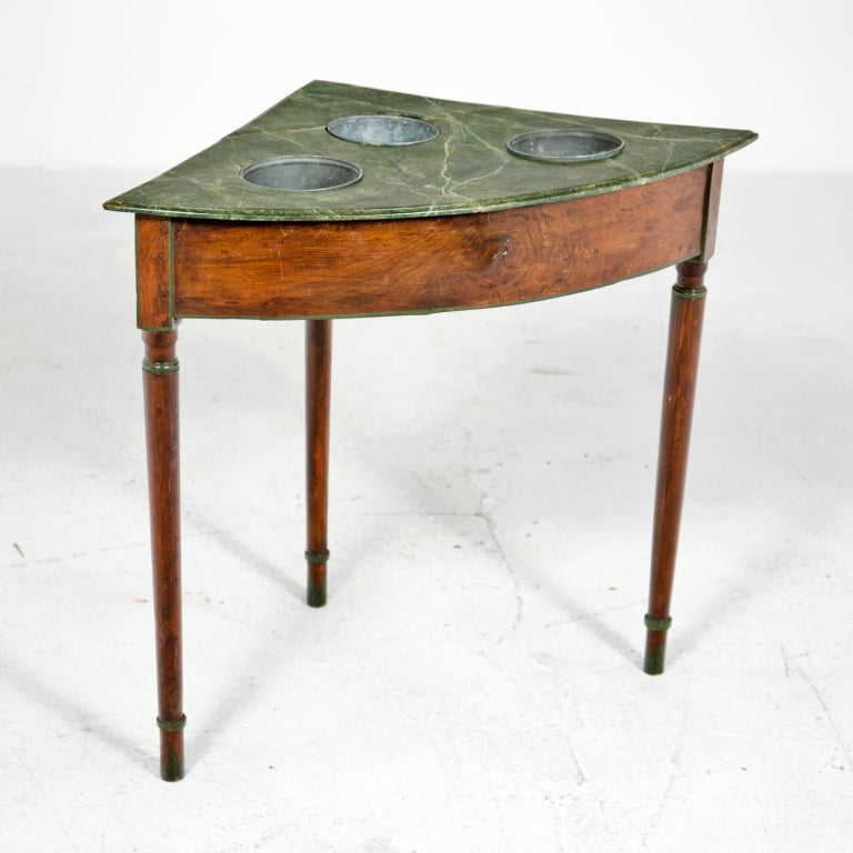 Rare and beautiful fruitwood corner wine tasting table with painted faux marble top and metal wine holders made during the 19th century. Classic turned tapered legs with good old surface. We have seen the wine holders used to hold orchids and