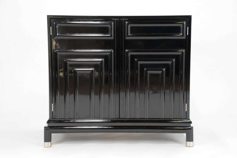 Renzo Rutili cabinets for Johnson furniture company. This handsome set are complete redone in a custom black lacquer with a french polish. The feet and hinges have been plated in satin nickel. Each cabinet has a single adjustable lacquered shelf.