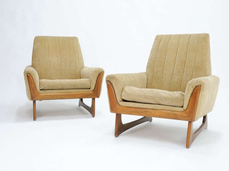 A Pair of club chairs By Adrain Pearsell.  The chairs are in need of new upholstery and refinishing of the walnut. Arm Height is 21