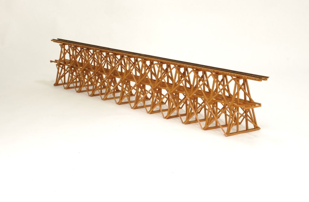 A wonderful hand made train trestle model.  This trestle model is finely detailed down to the model spikes to hold the wood support beams together. I object to be admired for years.