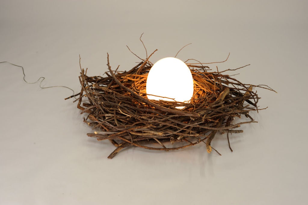 A playful and intelligent artist Eagle Nest floor lamp.  Hand made in the 1960's is this nest floor lamp made from interwoven branches and a wonderful glass egg. This clever light would be a highlight to any loft. Hand crafted in the bay area in the