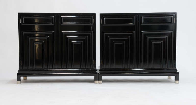 A pair of Renzo Rutili cabinet for Johnson furniture company. This handsome pair are complete redone in a custom black lacquer with a french polish. The feet and hinges have been plated in satin nickel. Each cabinet has a single adjustable lacquered