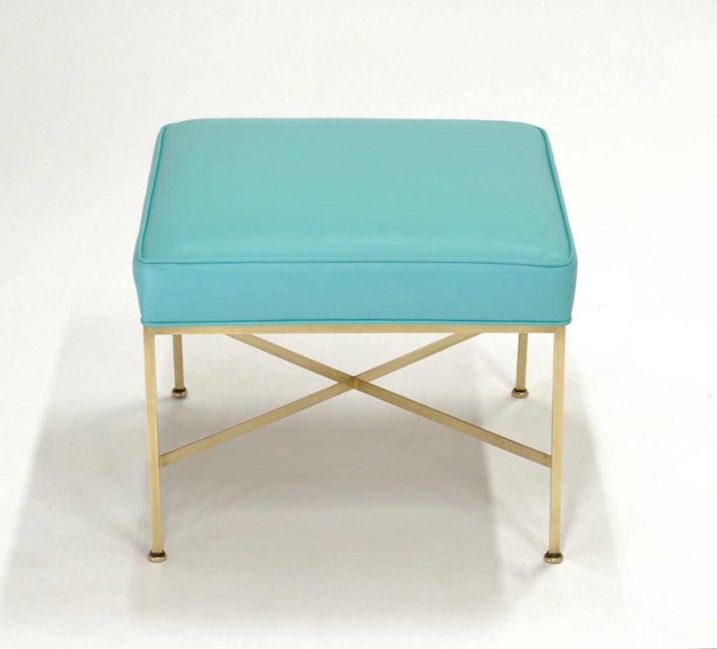 This ia a pair Paul McCobb's All-Round Square, Brass X-Stretcher Base model 1306 for Directional Designs. The brass base in highlighted by the beautiful carribean aqua blue leather cushions.
