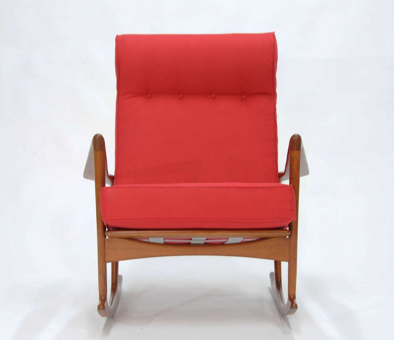 A handsome and Bold Rocking chair by Korford-Larsen for Christensen-Larsen and imported by Selig.  This is a early model of this chair and has been handsomely refinished to it's original color and upholstery pattern.  The Fagas straps are new and