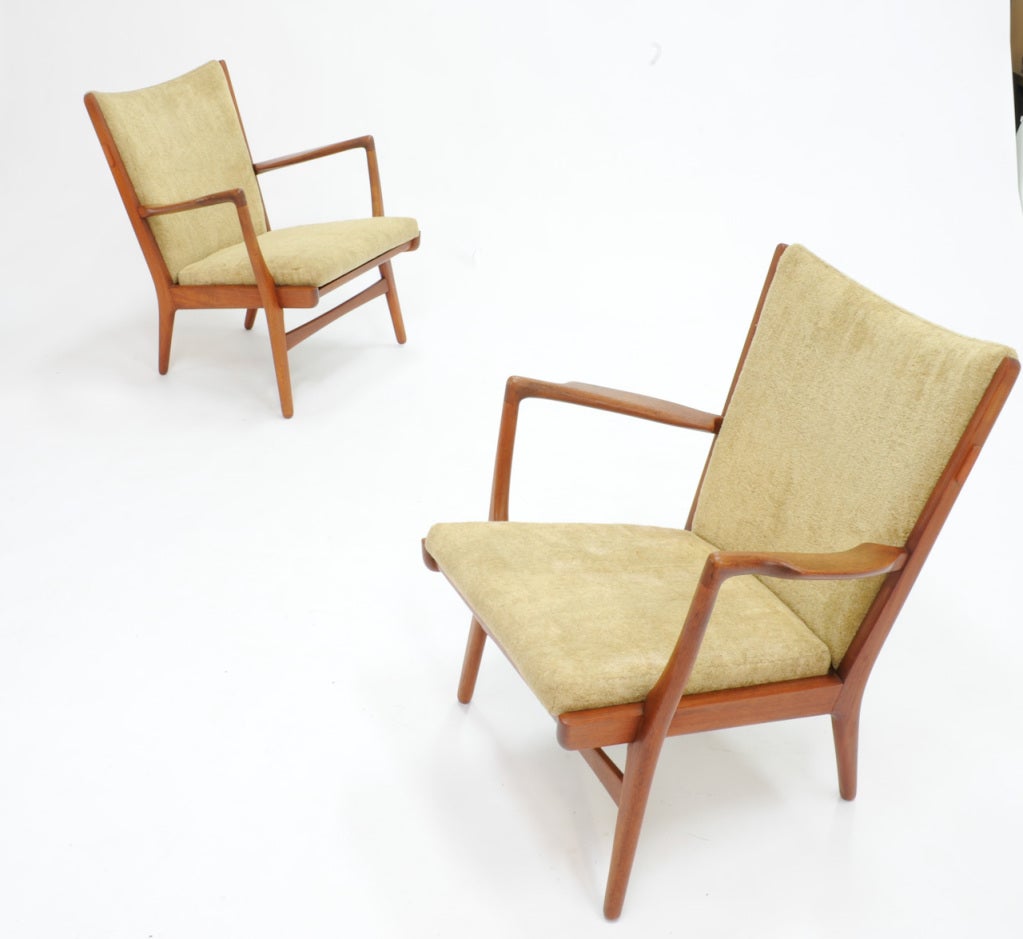 These are early and rare AP 16 easy chairs by Hans Wegner for A.P. Stolen.  The elegant arms and rich details are trademark Wegner.