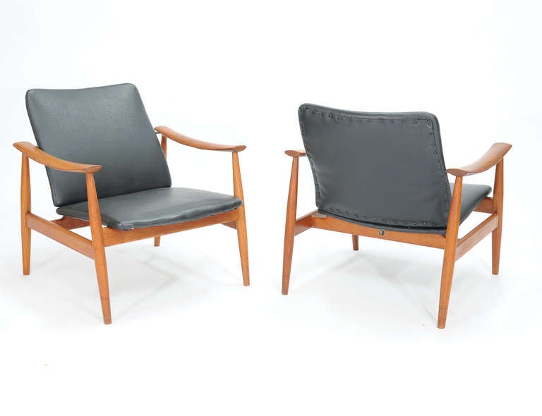 A handsome pair of Finn Juhl club chairs for France & Sons. Arm height is 22