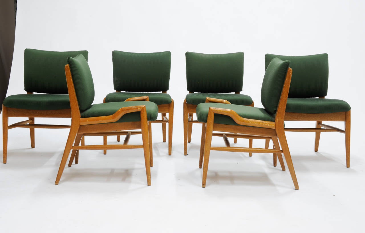 An original condition John Keal for Brown and Saltman dining set. The table is a double drop-leaf with six chairs. Two armchairs and four side chairs. Table and chair can be sold separately.