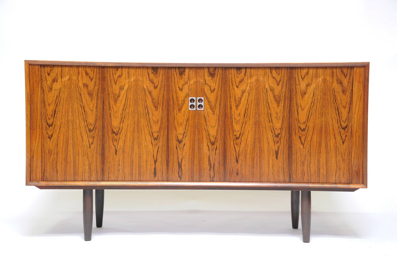 Each credenza is a small work of art in it's own right and has unique grain patterning. They came directly from Denmark and were from a single family estate. Each credenza has two shelves and beautiful tambour doors. They feature the two finger pulls