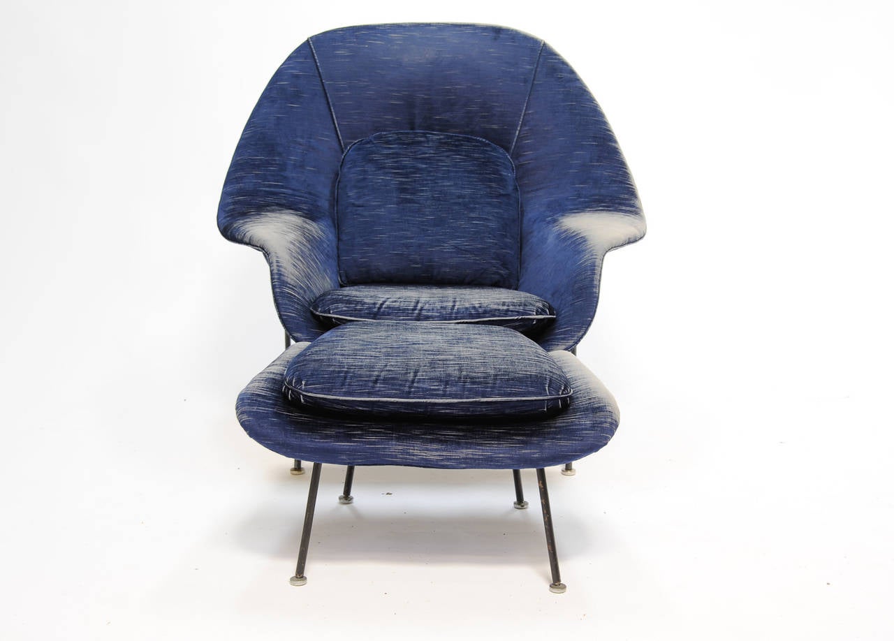 This womb chair is all original and features the moon landing feet. The fabric has aged in a wonderful why to appear to be worn demin. Few chairs are more iconic or comfortable in American Modern design.